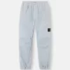 Löst sittande sweatpants med tryckknappar och fickor med dragkedja