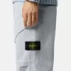 Löst sittande sweatpants med tryckknappar och fickor med dragkedja
