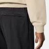 Löst sittande sweatpants med tryckknappar och fickor med dragkedja