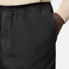 Löst sittande sweatpants med tryckknappar och fickor med dragkedja
