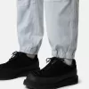 Löst sittande sweatpants med tryckknappar och fickor med dragkedja